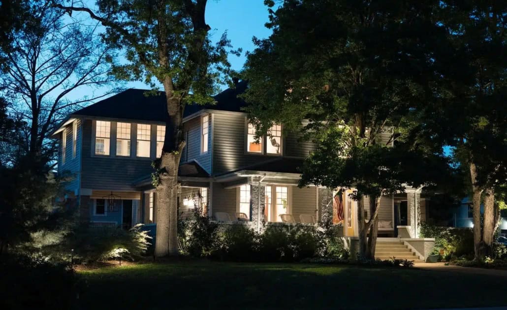 Lumos Outdoor Lighting In Waco, TX Elegant home at dusk showcasing outdoor lighting. Soft light illuminates the facade, highlighting the architecture and landscaping, creating a warm and inviting ambiance.