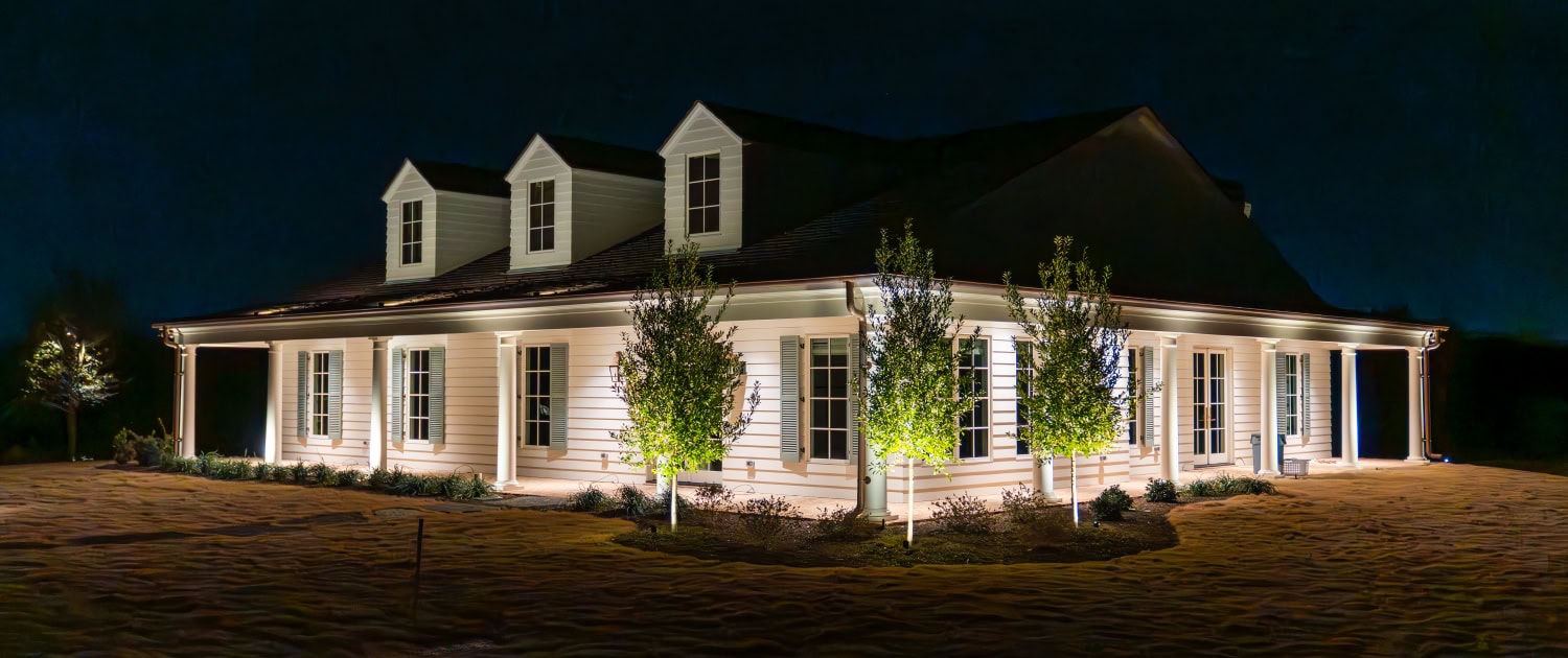 Lumos Outdoor Lighting Home Exterior Night view of a house illuminated with outdoor lighting, showcasing landscape and architectural features for enhanced curb appeal.